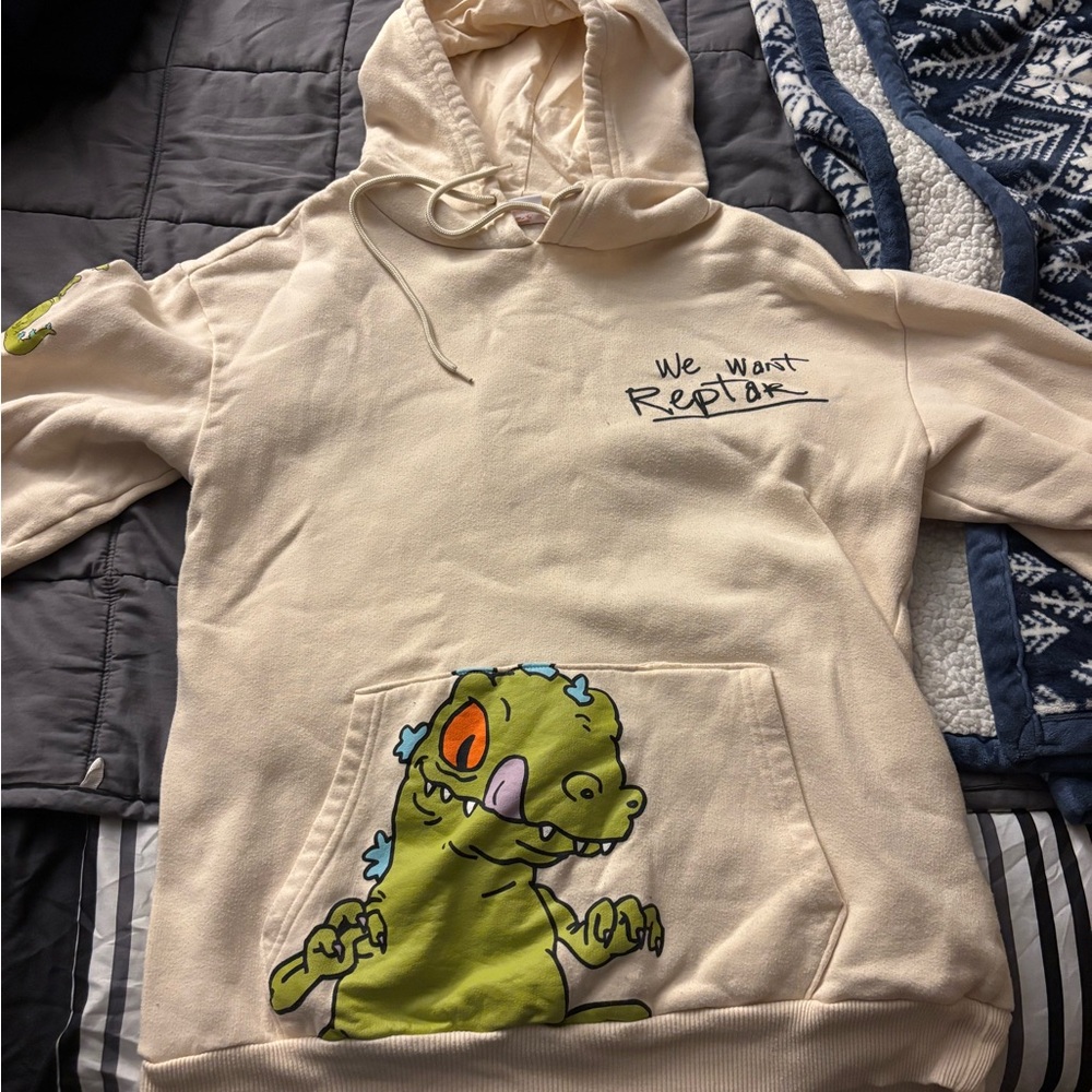 We Want Reptar Cream Hoodie with Green Reptile Graphic